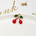 Detail of a cherry pendant with red enamel and green leaves on a white porcelain plate - 19# 3D Cherry