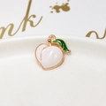 Macro shot of peach-shaped alloy pendant with pink enamel and gold-plated details - 23# White Peach