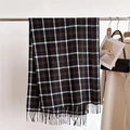 Detail of soft black and brown plaid scarf featuring decorative tassels on a metal hanger - Black Brown & White Plaid (WT154-1)