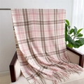 Close-up of pink and khaki plaid cashmere-like scarf with soft tassels on a chair - Pink & Khaki Plaid (WT143-3)