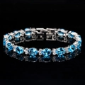 Macro shot of silver bracelet featuring oval blue gemstones and sparkling zircon accents - Aquamarine