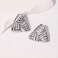 Minimalist silver triangle stud earrings with textured radial stripes on stone background - Steel