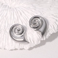 Silver conch shell earrings in high-polished stainless steel on a white coral base - Steel