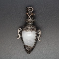 Detailed view of vintage copper hollow pendant with a translucent white crystal stone - White Crystal