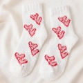 Soft white coral fleece socks featuring red heart bow patterns for winter warmth - One Size / White Red Bow