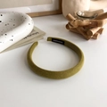 Detail view of mustard yellow fabric headband with handmade label on white background - Matcha Green