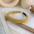 Detail of yellow padded headband showing handmade label and premium fabric texture - Yellow