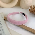Detail of pink fabric sponge headband with handmade label in an aesthetic setting - Pink