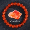 Macro shot of polished orange carnelian bead bracelet with natural raw gemstone - Red Agate