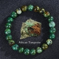 Elastic beaded bracelet made of natural African Turquoise stones with a raw ore sample - African Pine Stone