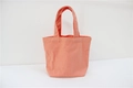 Front view of small coral pink canvas lunch bag with single handle on white background - Orange Red (Open)