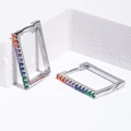 Silver rectangular hoop earrings with colorful rainbow cubic zirconia on white background - Silver