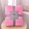 Detail of folded pink flannel blanket with vertical stripes and elegant ribbon packaging - Pretty Pink