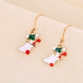 Close-up of Christmas stocking drop earrings in festive red, white and green enamel - Red and White Enamel Christmas Sock