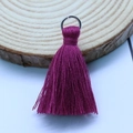 Magenta purple tassel pendant with silver metal ring on a rustic wooden slice - Burgundy