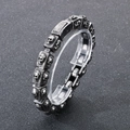 Macro shot of retro stainless steel square links with skull relief on a man's bracelet - Steel Color (KB179298-KJX)