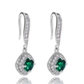 Macro shot of silver drop earrings featuring square green emerald-cut stones with halo crystals - Green
