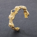 Detailed close-up of gothic gold skull bracelet with embossed bone patterns and black zircon - Gold (KB188542-KJX)