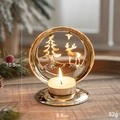 Golden Christmas tea light holder with reindeer and tree silhouette on a wooden surface - Christmas Tree and Reindeer