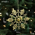 Golden Christmas snowflake ornament hanging on a festive tree branch for holiday decor - Snowflake E