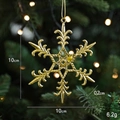 Golden 10cm snowflake ornament hanging on a Christmas tree with a detailed carved texture - Snowflake B