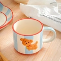 Close-up of blue striped ceramic mug featuring a 3D brown puppy relief and red rim - 300ml / Blue