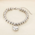 Detailed close-up of a silver beaded bracelet with heart pendant and adjustable link - Steel Color Round Bead Heart Style (KB187479-Z)