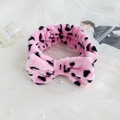 Pink and black leopard print plush bow headband on elegant soft white fur background - Pink Leopard Print