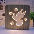 Detail of wooden night light with hollowed dove heart pattern and warm LED glow - Peace Dove/19cm