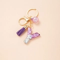 Detail of purple glitter resin letter Y keychain with purple tassel and gold hardware - Letter Y
