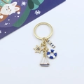Golden nautical keychain with sailboat, lifebuoy, rudder, and lighthouse charms - Sailboat/Lifebuoy/Rudder/Lighthouse