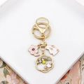 Detail of golden cherry blossom keychain with white rabbit and pink flower charms - Rabbit & Hollow Floral Moon