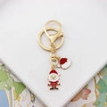 Detailaufnahme von Weihnachts-Nikolaus und Mützen-Emaille-Anhängern am Gold-Schlüsselring - Weihnachtsmann Hut