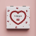 Close-up of portable square mirror with cute cherry and pink bow design on a soft pink base - Cherry Heart / White