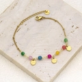 Detail of gold clover charm bracelet with colorful beads on a natural stone surface - Style 2 (Four-leaf Clover/Colorful Beads)