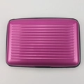 Top view of magenta aluminum card holder with ribbed texture and black protective edges - Rose Red