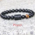 Pisces zodiac stretch bracelet with 8mm black beads and a unique tiger eye stone charm - Pisces
