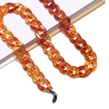 Detailed macro of amber acrylic eyeglass chain with durable metal loops and silicone grips - 16 Amber