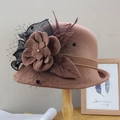 Elegant dark coffee felt cloche hat with floral mesh and feather on a wooden stand - Adjustable / Caramel color