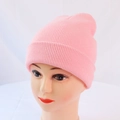 Close-up of pink ribbed knit beanie hat texture on mannequin for winter warmth - One Size / Light Pink
