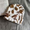 Detail of vintage cow print knitted beanie showing premium textured jacquard weave - One Size / Khaki Cow Print