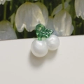 Macro shot of white pearl cherry charms with green translucent stems for DIY jewelry - White (Single)