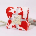 Soft red and white cow print flannel blanket tied with a silver ribbon gift wrap - Red Cow