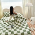 Green and white checkerboard plush blanket set with matching pillowcases on bed - Green and White Plaid