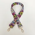 Detail of adjustable floral embroidered bag strap with premium gold metal swivel hooks - Small Floral Clusters / Gold Hooks