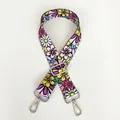 Detail view of ethnic floral embroidered bag strap with adjustable silver metal hooks - Small Floral Clusters / Silver Hooks