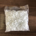 Bulk pack of white plastic stitch markers for knitting on a wooden background - White