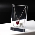 Detail of red oval gemstone pendant on silver chain hanging on acrylic display stand - Medium Transparent 6*3*10CM
