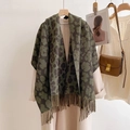 Detail of army green leopard print cashmere scarf with tassels on a hanger - Green Leopard