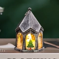 Detail of vintage silver Christmas lantern with warm LED candle on a book prop - Antique Silver - Christmas Tree